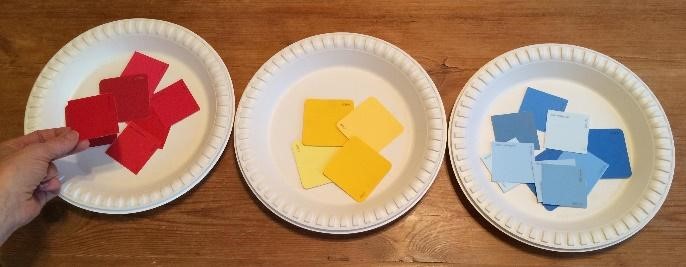 different colored paint chips cut up and put on paper plates