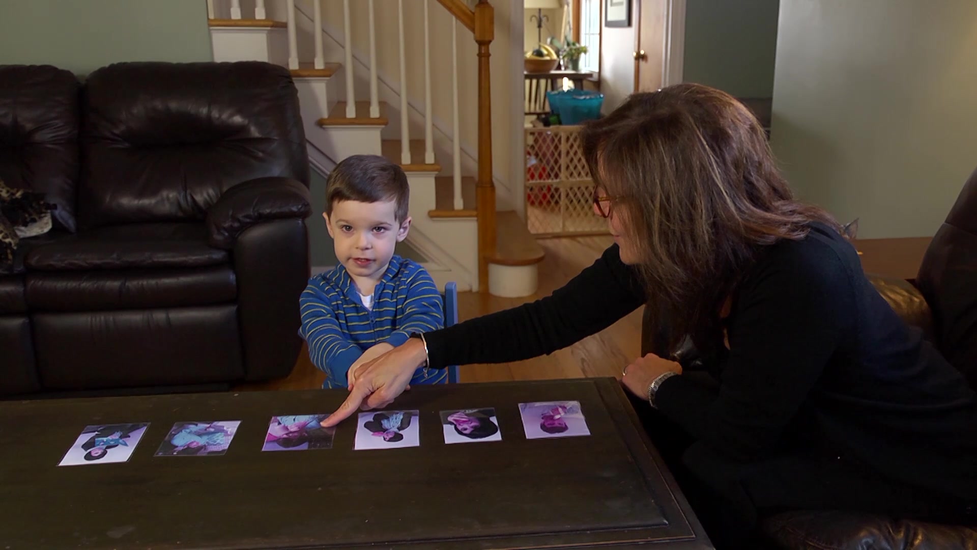 A woman point out a picture to a child