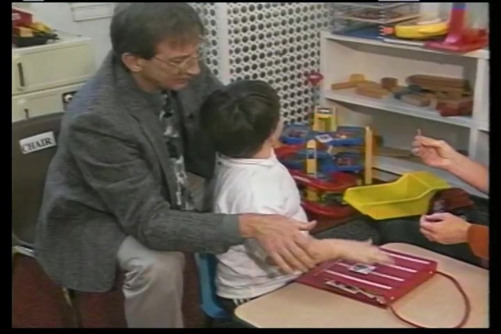 A father playing with his son in a play room