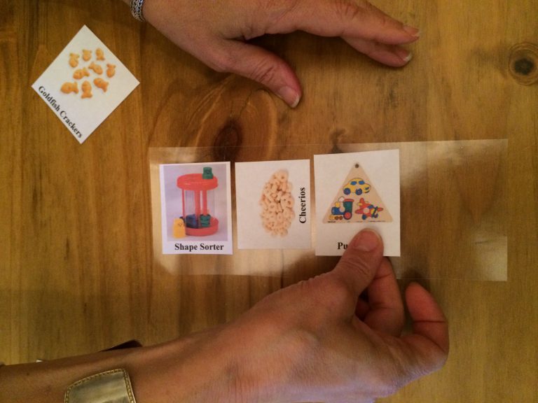 A woman placing pictures on a laminated sheet