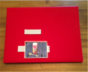 A PECS binder with a picture attached to the cover
