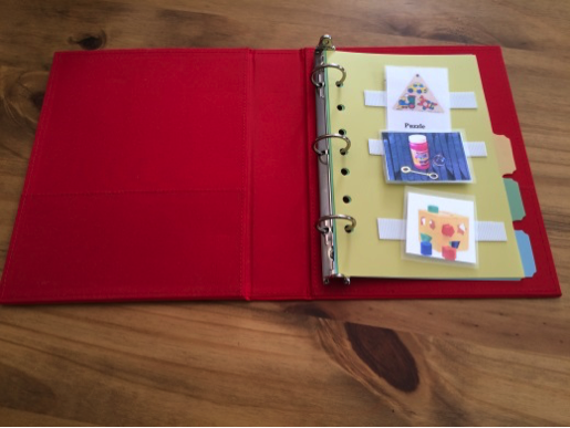 A PECS binder with filled pages