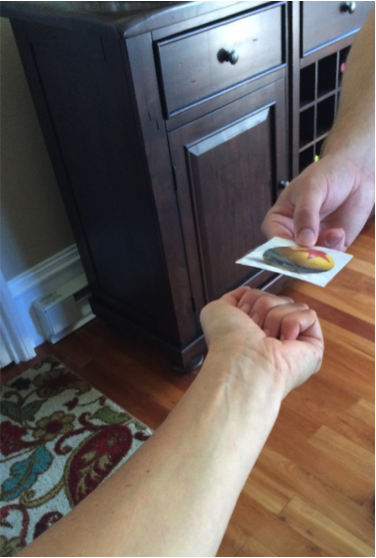 A child giving a picture to his mother